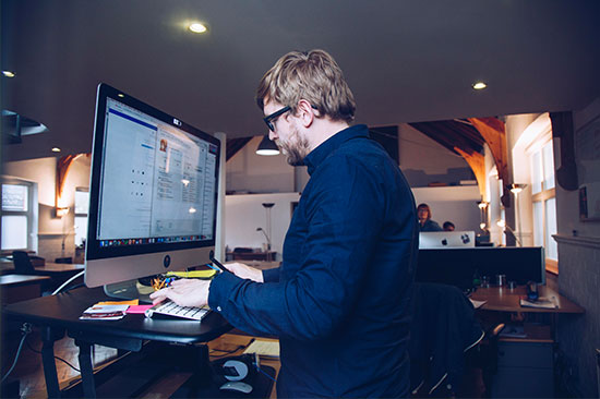 Dom observing a user research session from an iMac