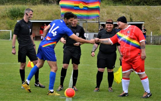 Utilita All-Stars' David James and Rainbow Rovers Captain and Manager Sophie Cook shake hands before the 2021 match