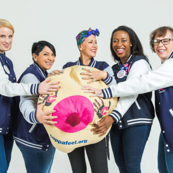 Five women holding a coppafeel inflatable boob prop